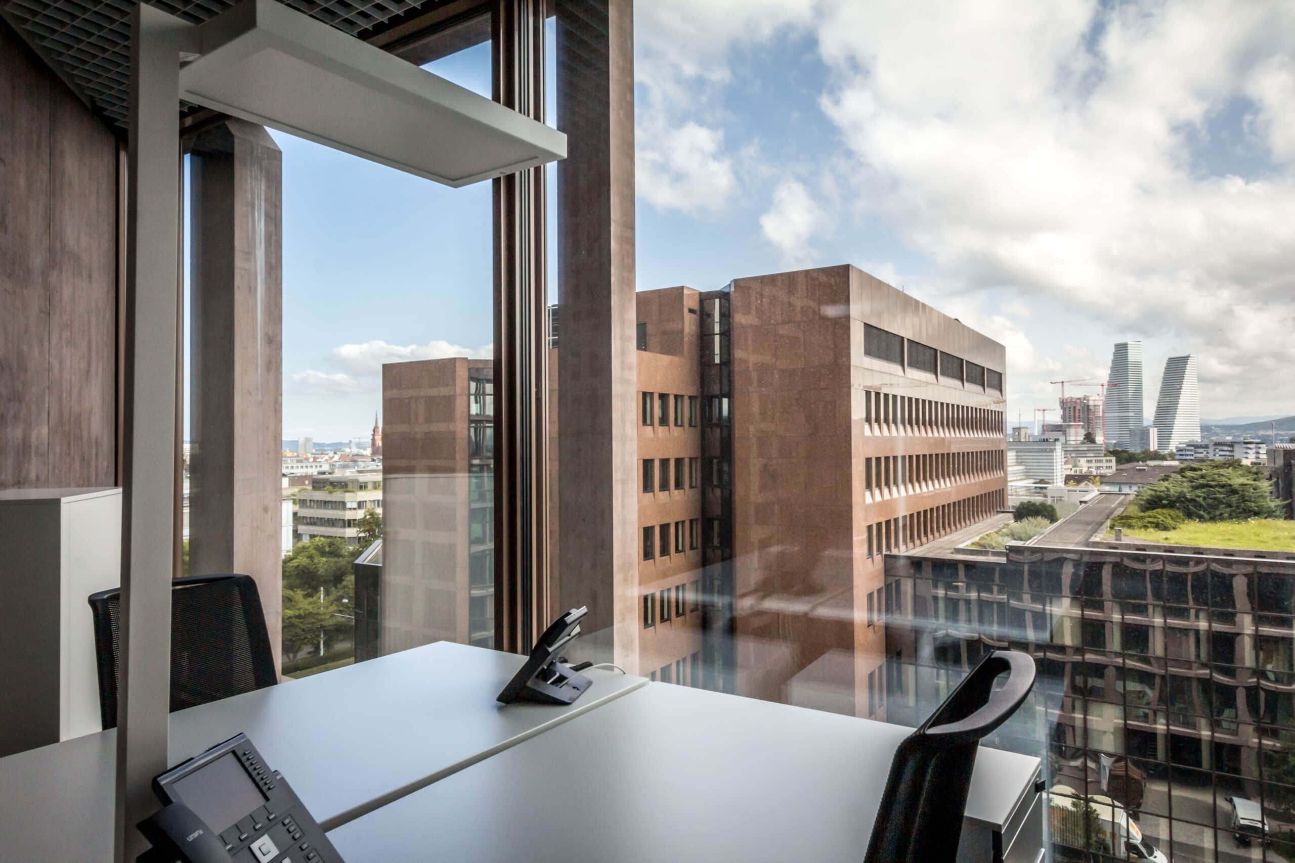 Office table is located directly at large window front with view