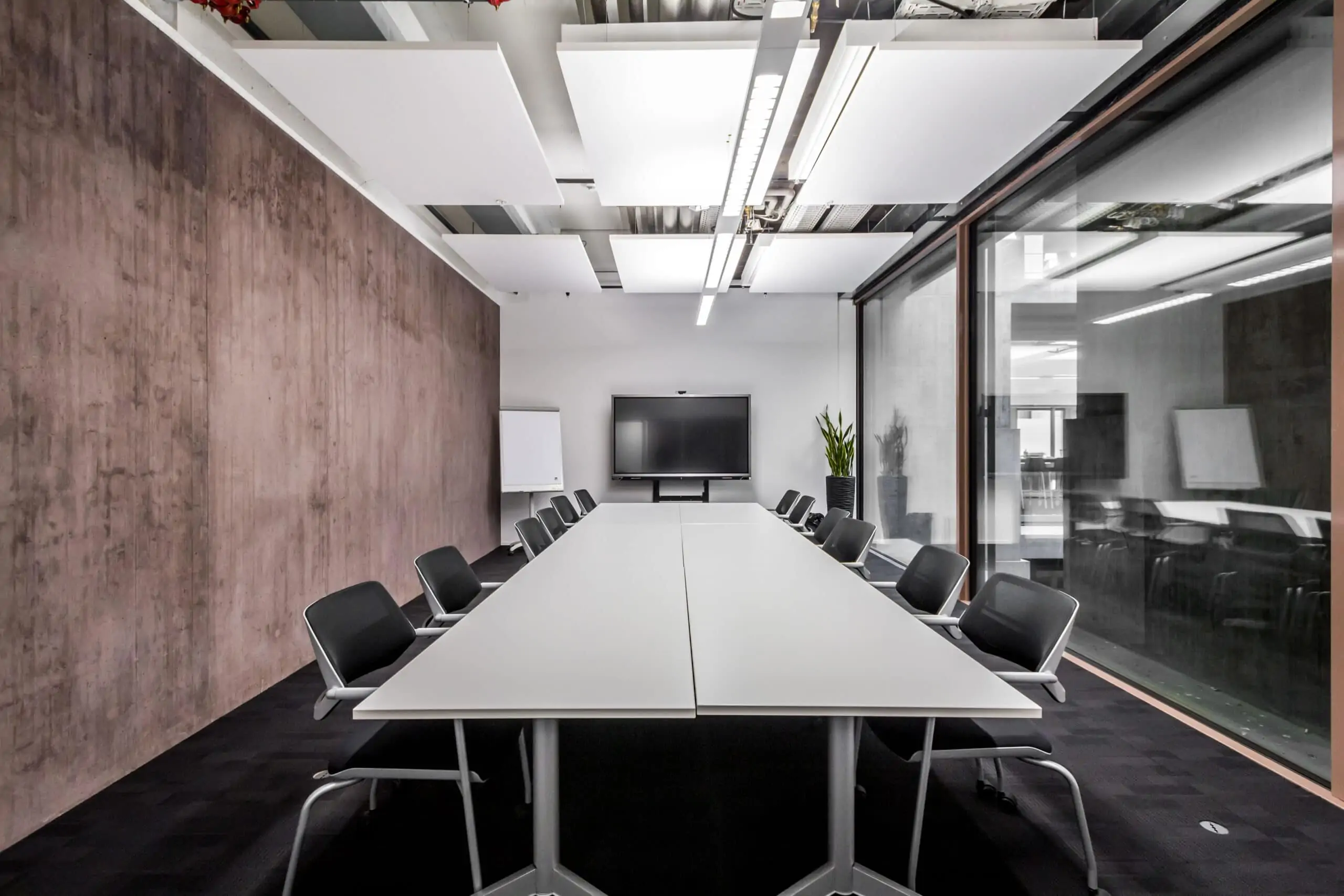 Modern meeting room with TV and glass front